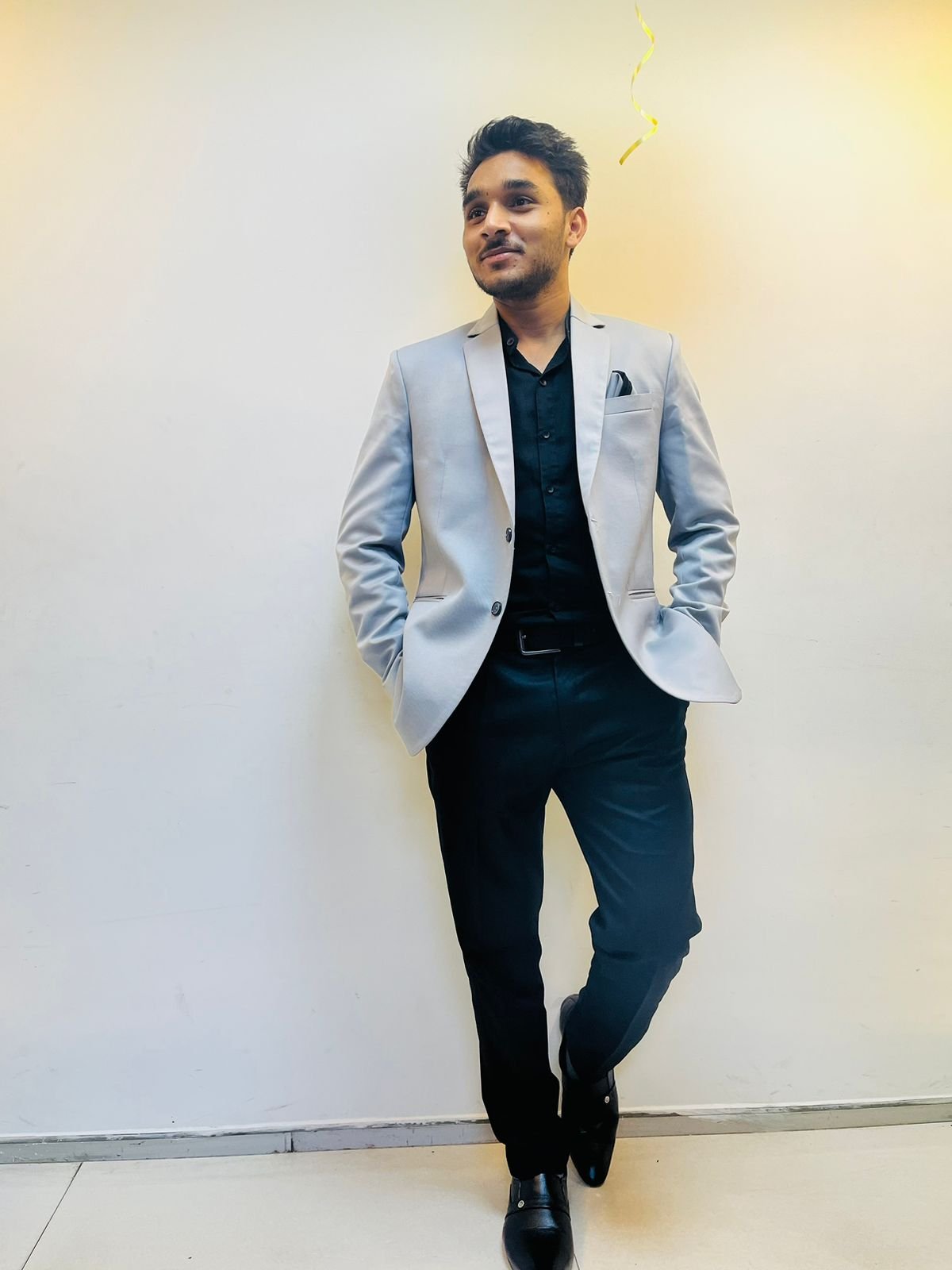 A man in a alice blue shirt with a thinking expression